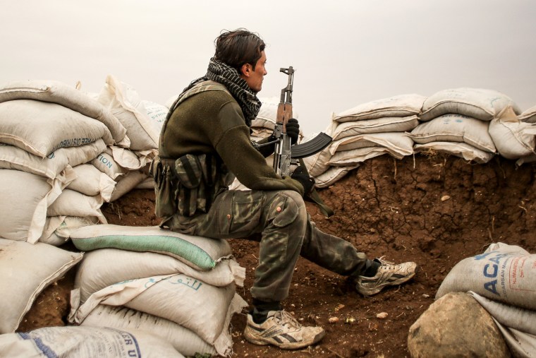 A Free Syrian Army fighter in the City of Hrjala in the countryside near Aleppo prepares to fight against ISIS on Dec. 10, 2014.