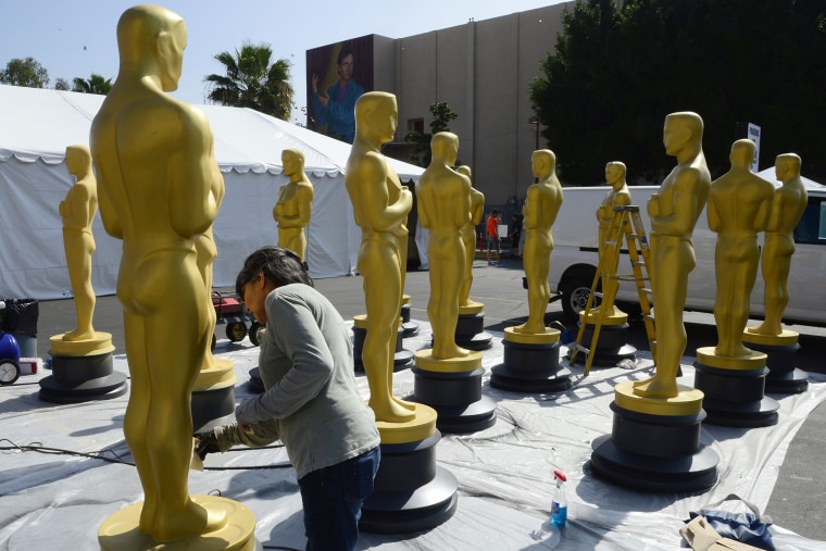 Virginia Belloni touches up Oscar statues as preparations for the 87th annual Academy Awards ceremony get underway in Hollywood, Calif. on Feb. 18, 2015.