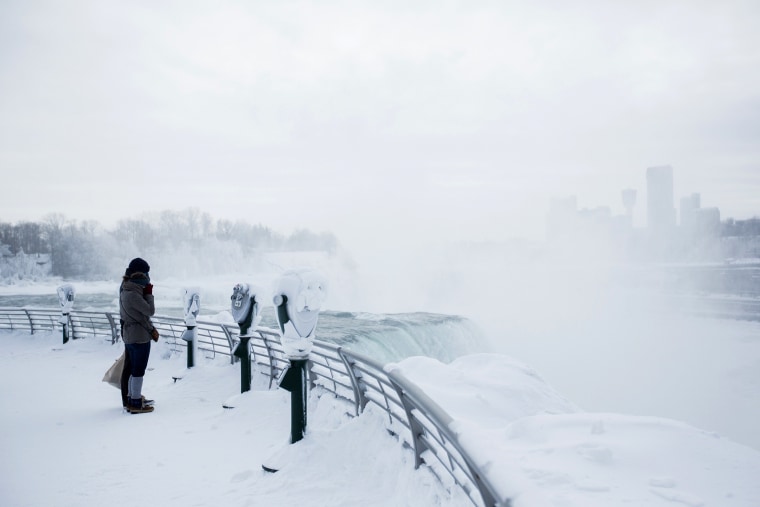 Visitors view frozen Niagara Falls in Niagara Falls, N.Y. on Feb. 17, 2015.