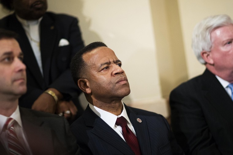 Former Atlanta fire chief Kelvin Cochran, second from left, listens during a rally by religious groups supporting Cochran following his termination, on Jan. 13, 2015, in Atlanta. (Photo by David Goldman/AP)