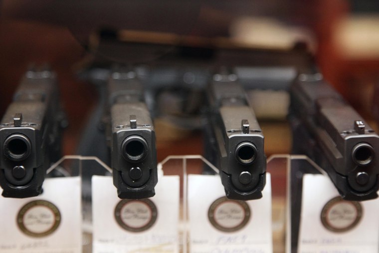 Handguns are displayed in the sales area of Sandy Springs Gun Club and Range, in Sandy Springs, Ga.