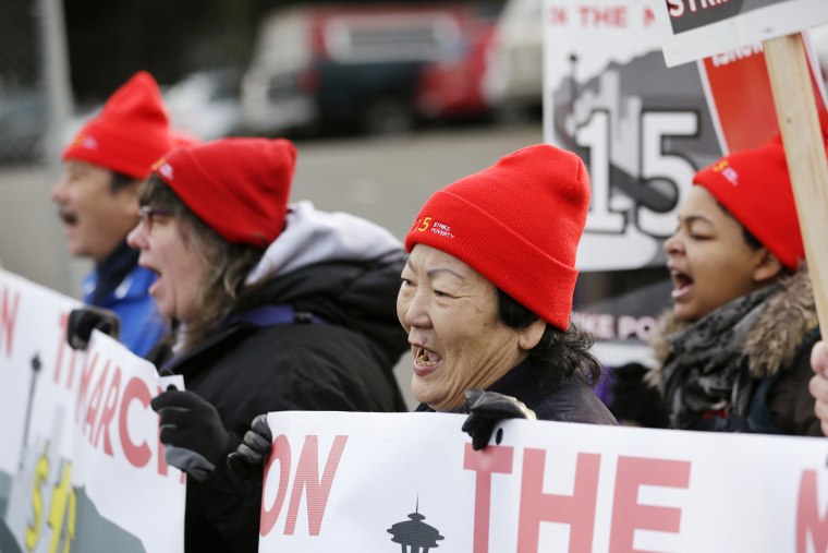 Sun Benjamin, a home health care worker, second right, walks with other protesters on a day-long march in support of low-wage workers on Dec. 5, 2013, in SeaTac, Wash.