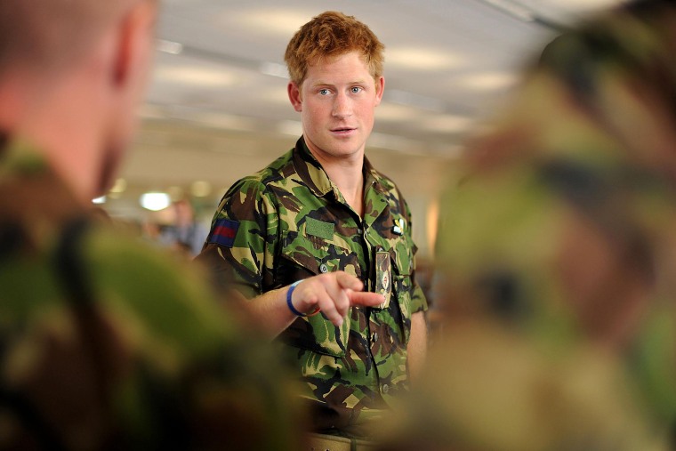 Prince Harry speaks with RAF personnel during a visit to RAF Honington Station in Suffolk, England on July 14, 2010. (Photo by Ben Stansall/PA Wire/AP)