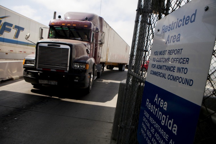 Truck drivers wait to speak to a US Customs and Border Protection officer soon after arriving in the US from Mexico at the Otay Mesa Port of Entry cargo facility in San Diego, Calif., June 7, 2013. (Photo by Sam Hodgson/Bloomberg via Getty)