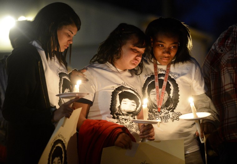 Zhakyra Cousin, center, Shia Brooks, left, and Markeesha McDade, right, during a Feb. 19, 2015 community vigil held in honor of Jessica Hernandez. (Photo by Andy Cross/The Denver Post via Getty)