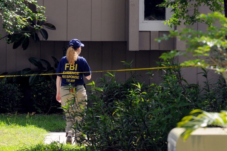 A Federal Bureau of Investigation (FBI) evidence response agent works outside an apartment complex where a suspected friend of the Boston bombers was shot and killed by FBI on May 22, 2013 in Orlando, Fl. (Photo by Gerardo Mora/Getty)