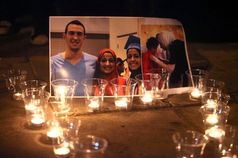 Candles are seen as a group of demonstrators gather in front of American Embassy in Amman to protest against the Chapel Hill shooting, in Amman, Jordan on Feb. 16, 2015. (Photo by Shadi Nsoor/Anadolu Agency/Getty)