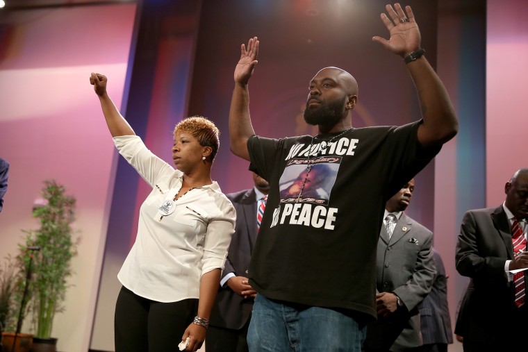 Lesley McSpadden (L) and Michael Brown, the parents of slain 18-year-old Michael Brown, acknowledge a crowd during an event at the Greater Grace Church on Aug. 17, 2014 in Ferguson, Mo. (Photo by Joe Raedle/Getty)