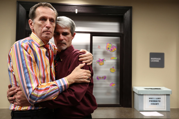 Robert Povilat, left, and Milton Persinger, comfort each other after hearing that for a second day, the Mobile County Probate office won't issue marriage licenses on Feb. 10, 2015 in Mobile, Ala.