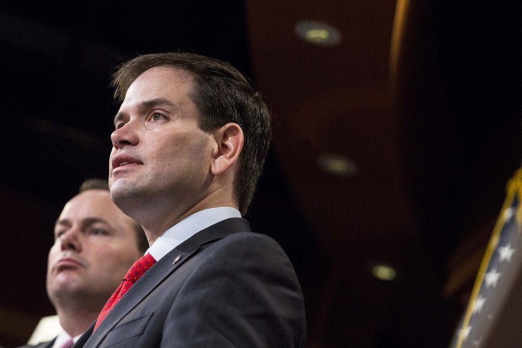 Sen. Marco Rubio (R-FL) speaks next to Sen. Mike Lee (R-Utah) during a news conference to introduce their proposal for an overhaul of the tax code, March 4, 2015 on Capitol Hill in Washington, DC. (Photo by Drew Angerer/Getty)