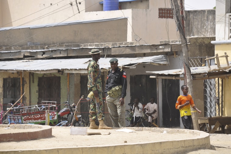 Security forces stand guard at the site of bomb explosion at a market in Maiduguri, Nigeria on March 7, 2015. (Photo by Jossy Ola/AP)