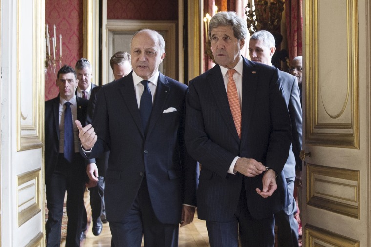 French Foreign Affairs Minister Laurent Fabius (L) and U.S. Secretary of State John Kerry speak as they arrive for a meeting at the French Foreign Affairs Ministry in Paris on March 7, 2015. (Photo by Etienne Laurent/Pool/Reuters)