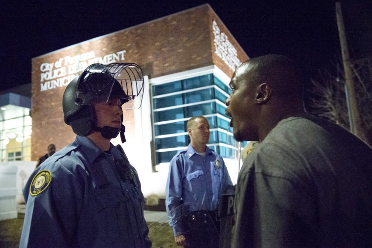 A protester confronts a police officer outside the City of Ferguson Police Department and Municipal Court in Ferguson, Missouri, March 11, 2015. (Photo by Kate Munsch/Reuters)