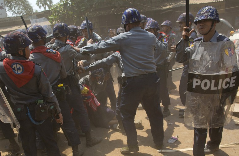 Police officers beat a student protester lying on the ground following a crackdown in Letpadan, about 90 miles north of Yangon, the capitol of Myanmar on March 10, 2015.