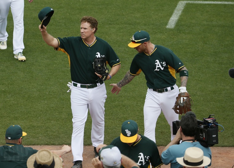 Actor Will Ferrell, left, tips his cap after playing shortstop for the Oakland Athletics during the first inning of a spring training baseball game against the Seattle Mariners, on March 12, 2015, in Mesa, Ariz.