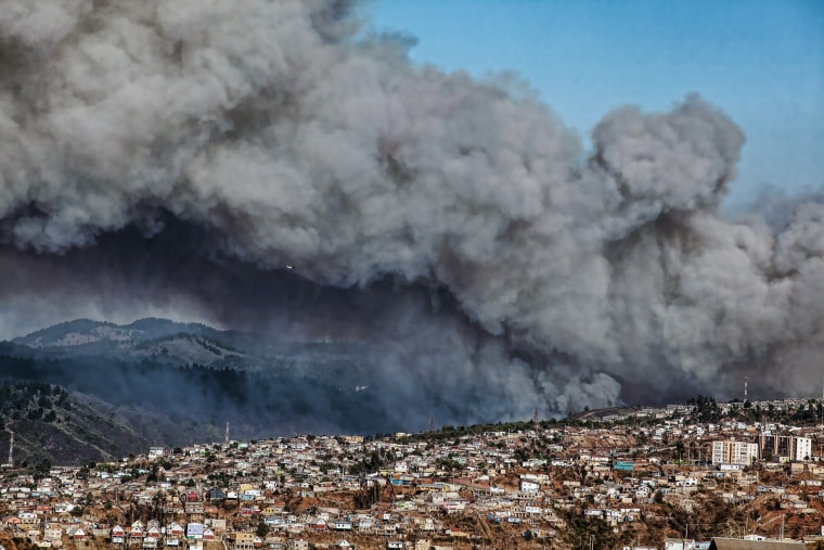 Smoke billows from the forest around Valparaiso, in Chile, on March 13, 2015 as the fire threatens to reach the city's port. Authorities have declared a red alert in the area. (Photo by Francesco Degasperi/AFP/Getty)