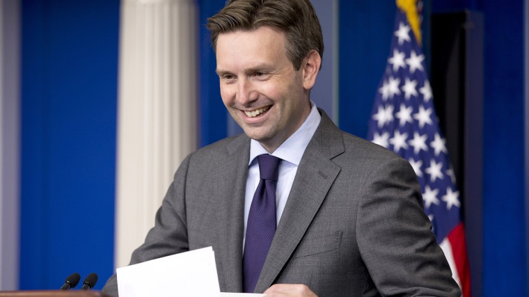White House press secretary Josh Earnest laughs as he enters the briefing room to speak to the media during his daily news briefing at the White House in Washington, D.C., July 11, 2014. (Photo by Jacquelyn Martin/AP)