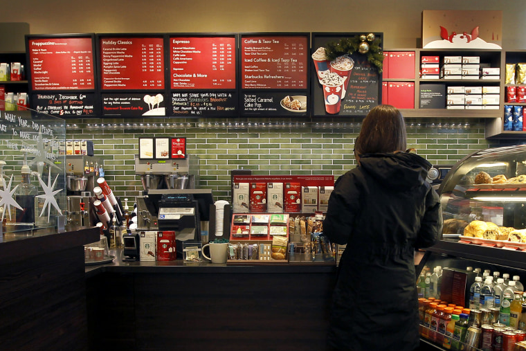 A Starbucks customer orders at a Chicago area store, Dec. 5, 2012. (Photo by Charles Rex Arbogast/AP)
