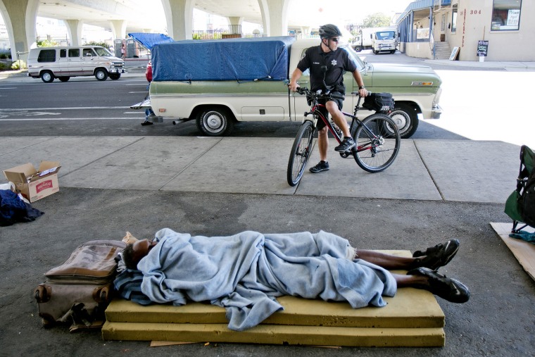 Boise bike police officer Andy Johnson stops in front of a homeless encampment under the S. 16th Street bridge on Sept. 4, 2014.