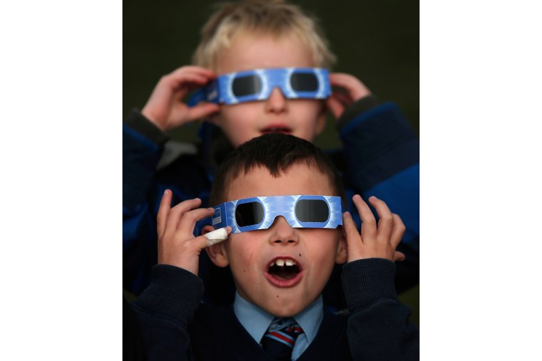 Students wear protective glasses as they view a partial solar eclipse from St. Vincent's Catholic Primary School in Altrincham, northern England March 20, 2015. (Photo by Phil Noble/Reuters)