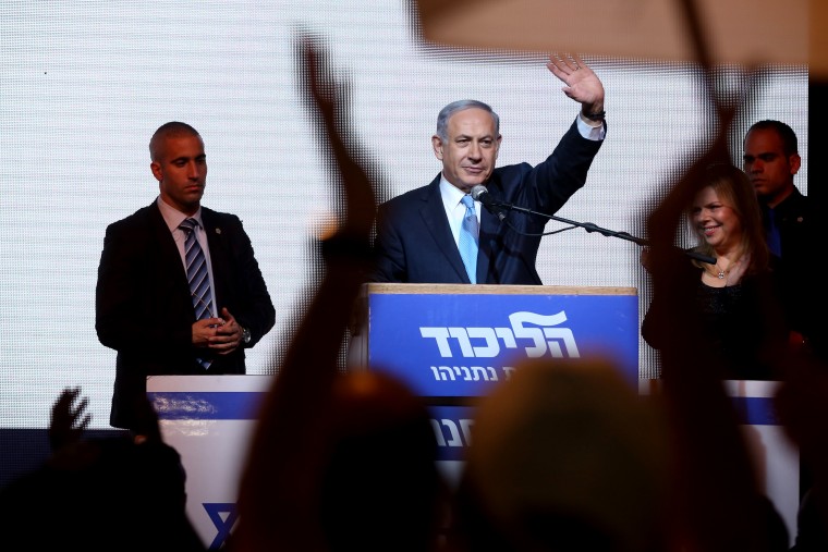 Israeli Prime Minister Benjamin Netanyahu delivers a speech next to his wife Sara as he reacts to exit poll figures in Israel's parliamentary elections late on March 17, 2015 in the city of Tel Aviv. (Photo by Menahem Kahana/AFP/Getty)