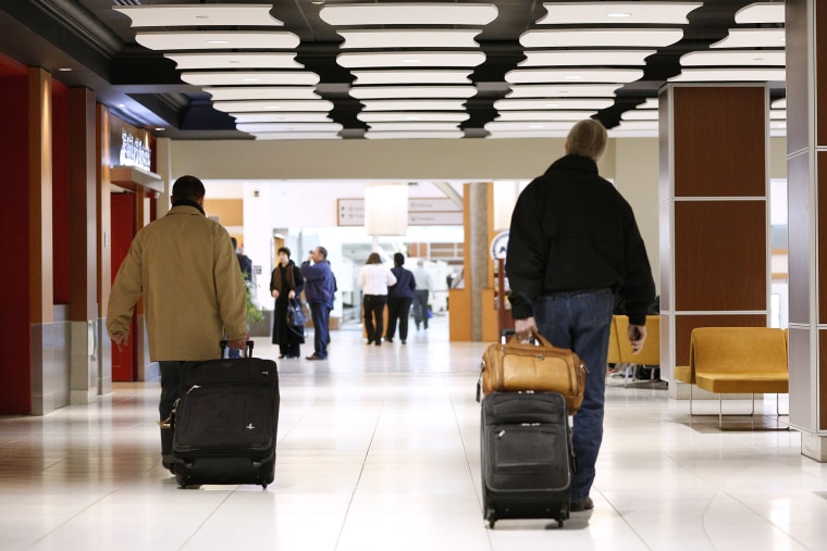 Passengers walk through the terminals of Louis Armstrong International Airport in Kenner, La. on Jan. 29, 2014.