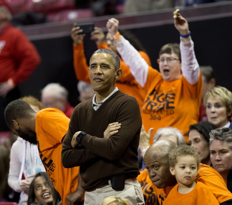President Barack Obama watches the player's introductions of the Princeton vs Green Bay women's college basketball game inCollege Park, Md., March 21, 2015. Obama's niece, Leslie Robinson, plays for Princeton.(Photo by Pablo Martinez Monsivais/AP)