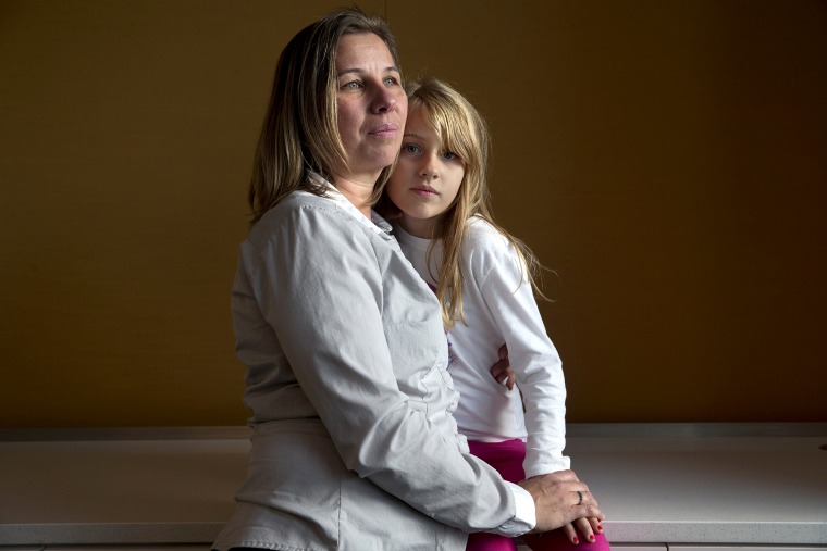 Peggy Young, of Lorton, Va., with her daughter Triniti, 7, photographed in Washington, D.C., on Nov. 14, 2014. (Photo by Jacquelyn Martin/AP)