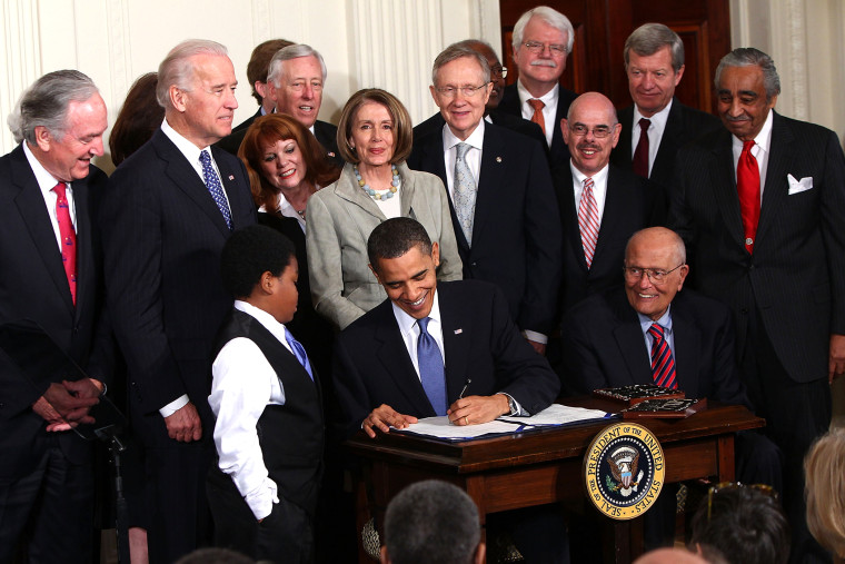 U.S. President Barack Obama signs the Affordable Health Care for America Act during a ceremony with fellow Democrats in the East Room of the White House March 23, 2010 in Washington, D.C. (Photo by Win McNamee/Getty)
