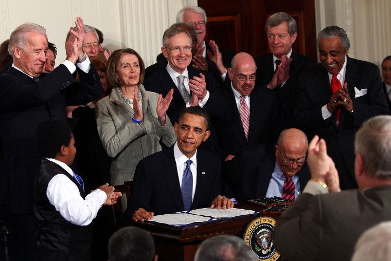 President Barack Obama is applauded after signing the Affordable Health Care for America Act during a ceremony with fellow Democrats in the East Room of the White House March 23, 2010 in Washington, DC. (Photo by Win McNamee/Getty)