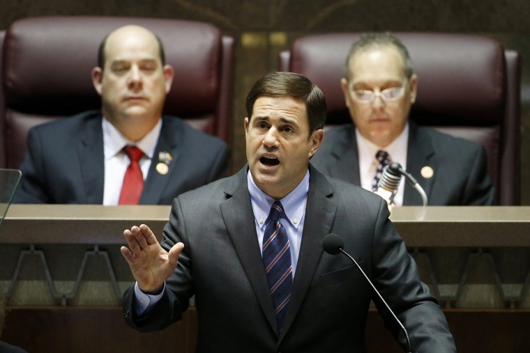 Arizona Republican Gov. Doug Ducey, front, gives his state-of-the-state address on Jan. 12, 2015, in Phoenix. (Photo by Ross D. Franklin/AP)