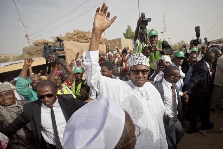 Gen. Muhammadu Buhari waves to supporters after casting his vote in his home town of Daura, northern Nigeria on March 28, 2015. (Photo by Ben Curtis/AP)