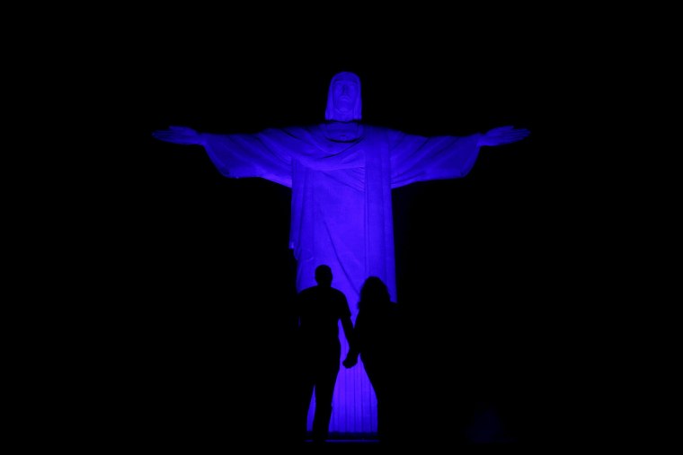 The statue of Christ the Redeemer is lit up in blue for the Light It Up Blue campaign to mark the World Autism Awareness Day in Rio de Janeiro April 1, 2015.