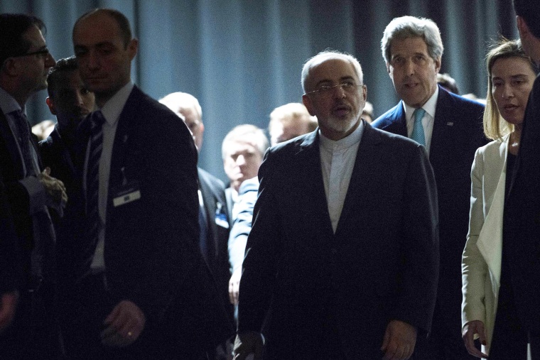 Iranian Foreign Minister Javad Zarif, centre, arrives with US Secretary of State John Kerry, background centre right and European Union High Representative Federica Mogherini, second right, to make a statement at the Swiss Federal Institute of Technology, or Ecole Polytechnique Federale De Lausanne, in Lausanne, Switzerland, on April 2, 2015.