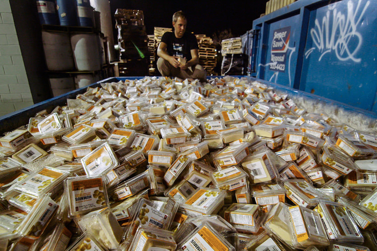 Director and “Just Eat It” documentary subject Grant Baldwin looks over a pile of discarded food. &nbsp;After just a couple months of rescuing food his refrigerator is and pantry are so full he has little room for more.&nbsp;
