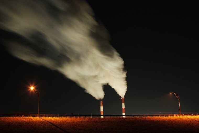 In this Jan. 19, 2012 file photo, smoke rises in this time exposure image from the stacks a coal-fired power plant in La Cygne, Kan. (Photo by Charlie Riedel/AP)