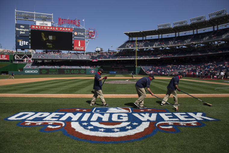 Washington Nationals groundskeepers prepare the field before an opening day baseball game between the New York Mets and Washington Nationals at Nationals Park on April 6, 2015, in Washington, D.C. (Evan Vucci/AP)
