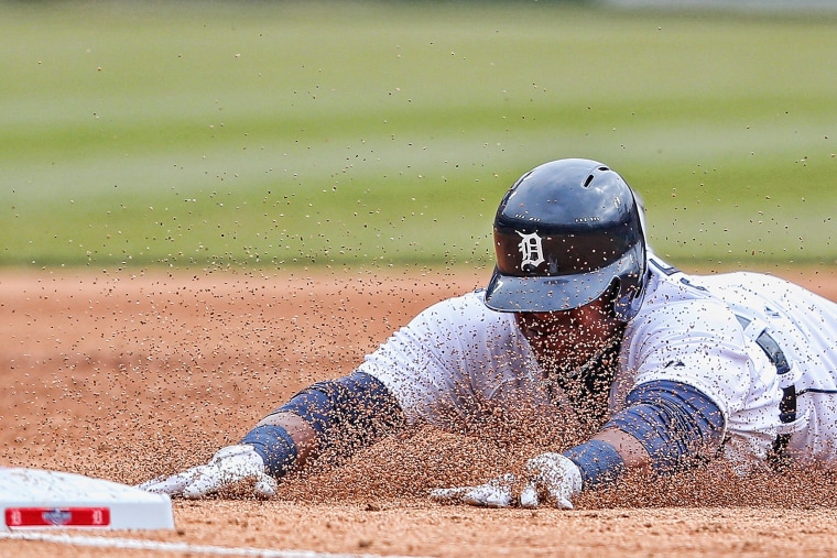 Yoenis Cespedes #52 of the Detroit Tigers slides into third base for a triple during the sixth inning of the Opening Day game against the Minnesota Twins at Comerica Park on April 6, 2015 in Detroit, Mich. (Photo by Leon Halip/Getty)
