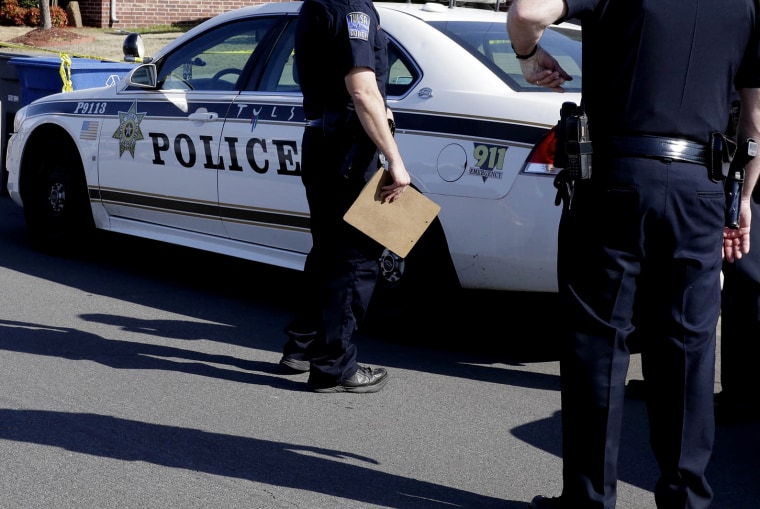 Tulsa police investigate a crime scene in Tulsa, Okla., April 1, 2015. (Photo by Michael Wyke/Tulsa World/AP)
