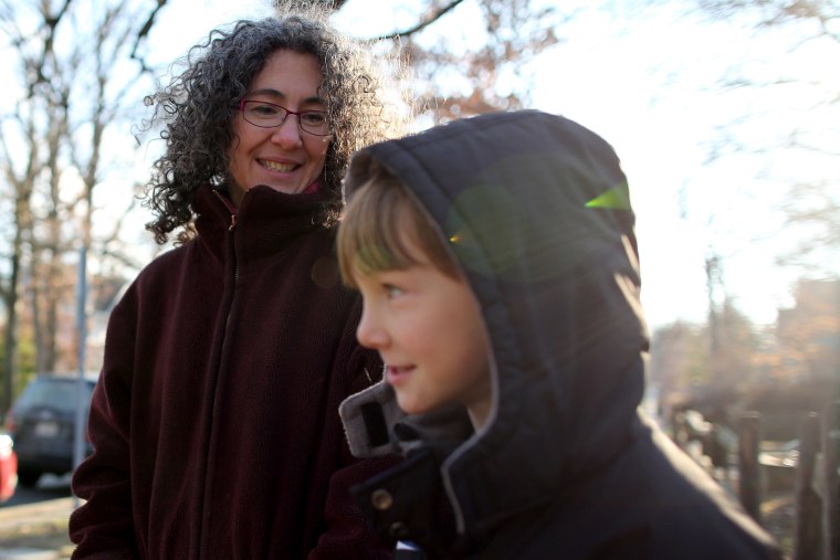Danielle Meitiv waits with her son Rafi Meitiv, 10, for Danielle's daughter Dvora Meitiv, 6, to be dropped off at the neighborhood school bus stop in Silver Spring MD, on Jan. 16, 2015.