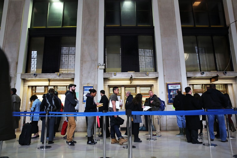 People wait in line in the James A. Farley post office in Manhattan, which is staying open until midnight on that last day to file taxes on April 15, 2014 in New York, N.Y. (Photo by Spencer Platt/Getty)