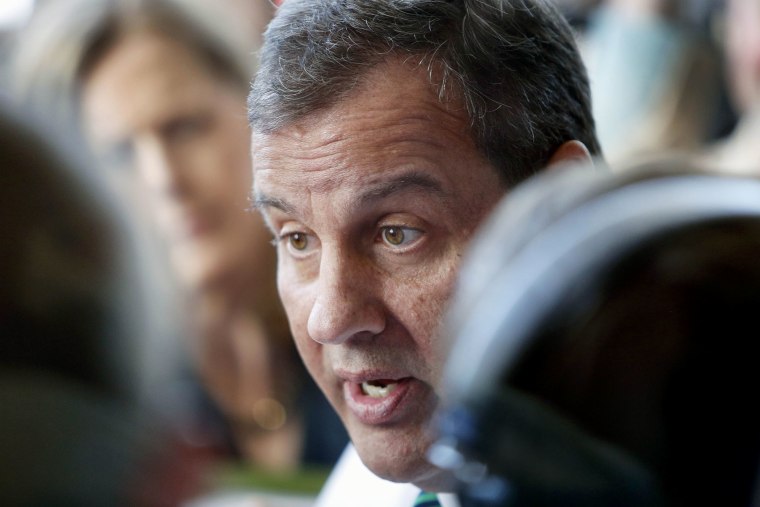 New Jersey Gov. Chris Christie, R-N.J. talks to reporters following a luncheon stop at Caesario's Pizza, on April 14, 2015, in downtown Manchester, N.H. (Photo by Jim Cole/AP)