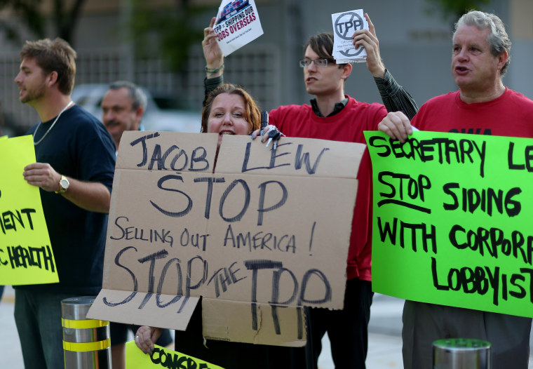Union members and community activists protest outside the Miami Dade College where the Greater Miami Chamber of Commerce and the college were hosting a moderated conversation with U.S. Secretary of the Treasury Jacob Lew on March 20, 2015 in Miami, Fla.