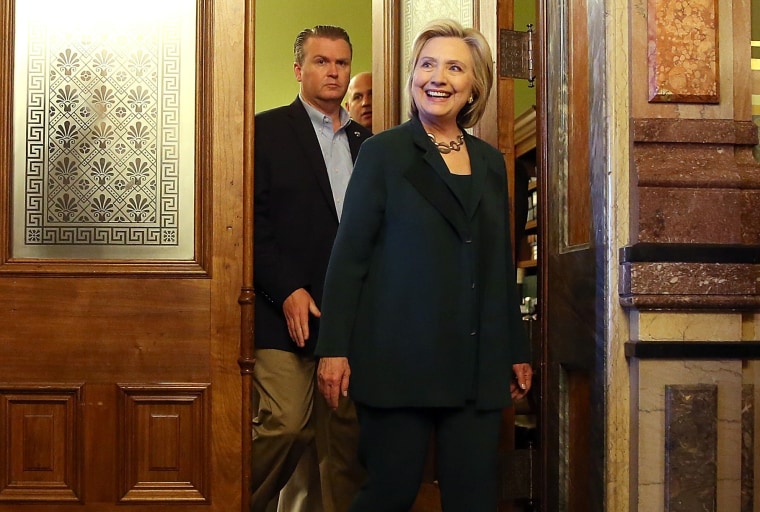 Democratic presidential hopeful and former Secretary of State Hillary Clinton (C) leaves a meeting with members of the Iowa State legislature at the Iowa State Capital on April 15, 2015 in Des Moines, Iowa. (Photo by Justin Sullivan/Getty)