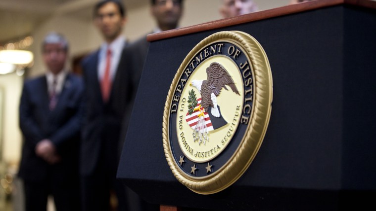 A US Department of Justice seal is displayed on a podium during a news conference on Dec. 11, 2012 in the Brooklyn borough of New York City. (Photo by Ramin Talaie/Getty)