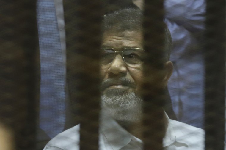 Egypt's ousted Islamist President Mohammed Morsi sits in a soundproof glass cage inside a makeshift courtroom at Egypt's national police academy in Cairo, Egypt, April 21, 2015. (Photo by Amr Nabil/AP)