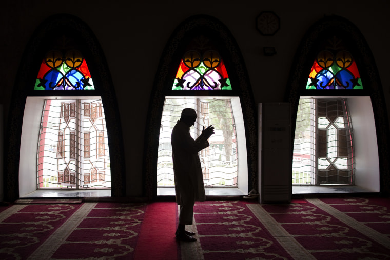 A Pakistani man performs Friday prayers at the Red Mosque in the capital Islamabad on July 8, 2011. (Photo by Behrouz Mehri/AFP/Getty)