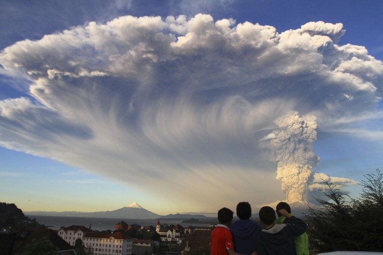Children watch the Calbuco volcano erupt, from Puerto Varas, Chile, April 22, 2015. (Photo by Carlos F. Gutierrez/AP)