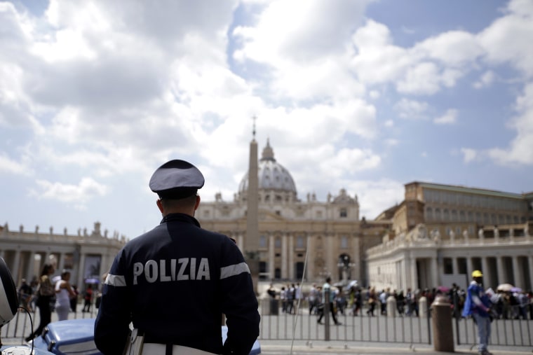 A police officer patrols outside St. Peter's Square, in Rome on April 24, 2015. (Photo by Gregorio Borgia/AP)