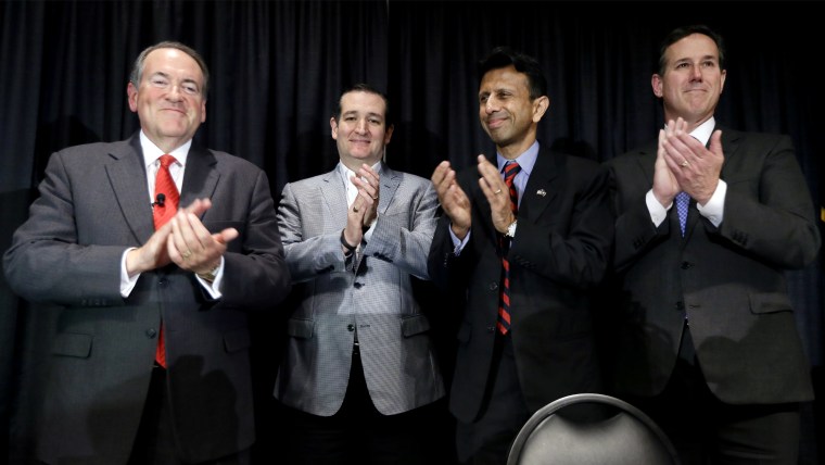Former Arkansas Gov. Mike Huckabee, Texas Sen. Ted Cruz, Louisiana Gov. Bobby Jindal and former Pennsylvania Sen. Rick Santorum gather after speaking at the Homeschool Iowa's Capitol Day, April 9, 2015, in Des Moines, Ia. (Photo by Charlie Neibergall/AP)